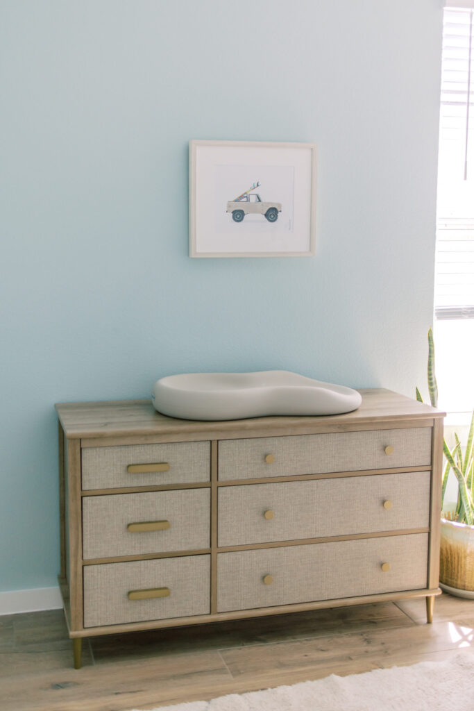 Baby blue nursery with dresser and changing pad.